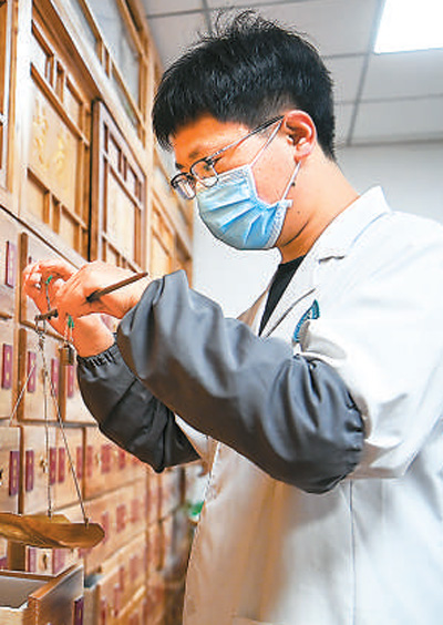 日前，陜西省西安市雁塔區(qū)電子城二〇五所社區(qū)衛(wèi)生服務(wù)站中醫(yī)館的藥劑師為患者配制中藥。新華社記者 鄒競一攝